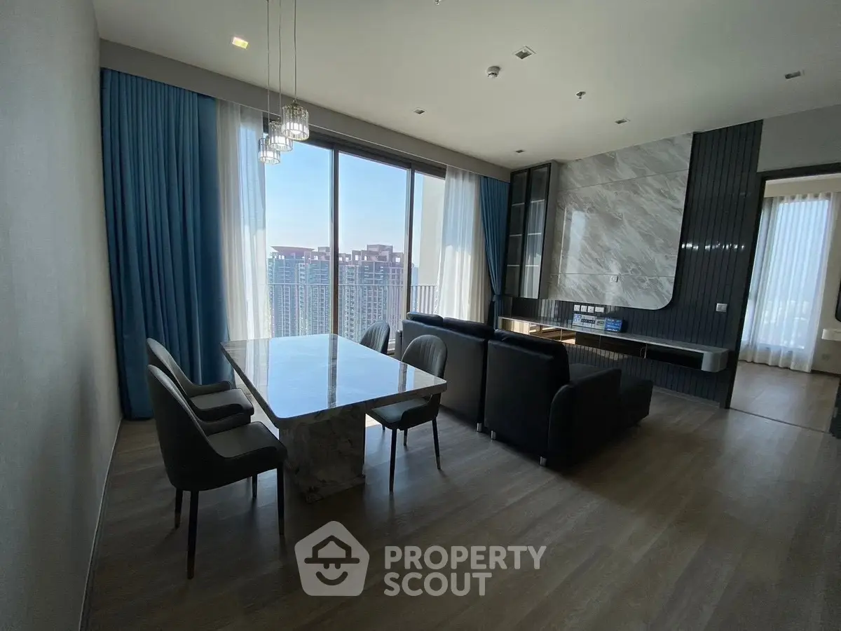 Luxurious modern living room with elegant marble dining table and stunning city view.
