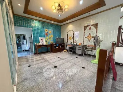 Spacious living room with decorative tiles and modern lighting in a stylish home.