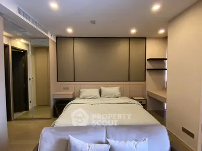 Luxurious bedroom with modern design, featuring a plush bed, built-in shelves, and ambient lighting.