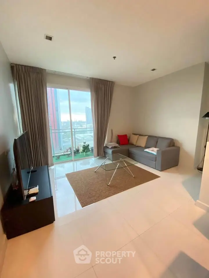 Modern living room with city view, sleek furniture, and large windows for natural light.