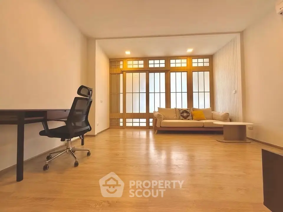 Spacious modern living room with wooden flooring and stylish furniture