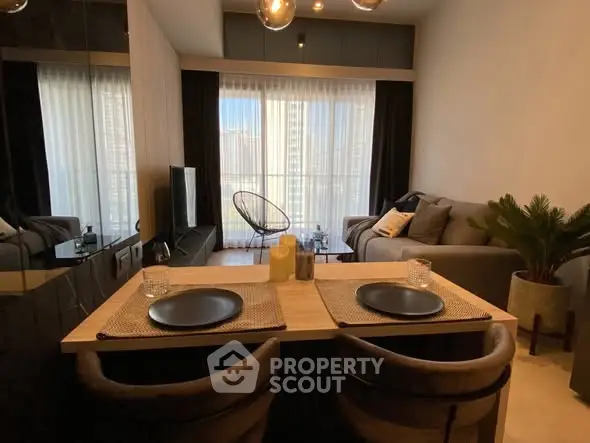 Modern living room with cozy seating and stylish decor, featuring a large window with city view.