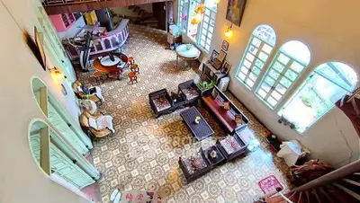 Spacious vintage living room with unique tile flooring and elegant decor