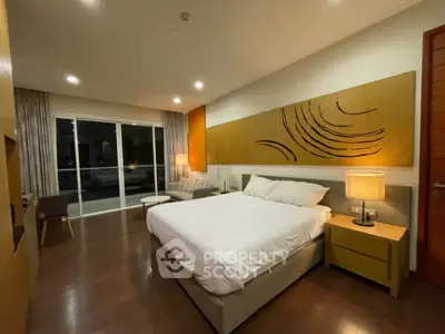 Luxurious bedroom with modern decor and large windows offering a serene ambiance.