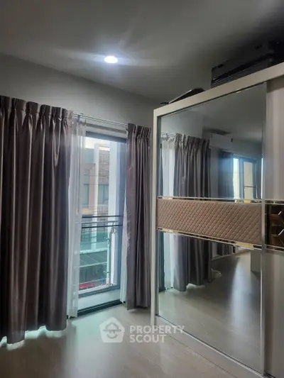 Modern bedroom with mirrored wardrobe and floor-to-ceiling windows