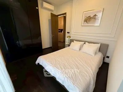 Modern bedroom with elegant decor and dark wood flooring