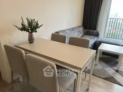 Modern living room with elegant dining table and cozy sofa near balcony view