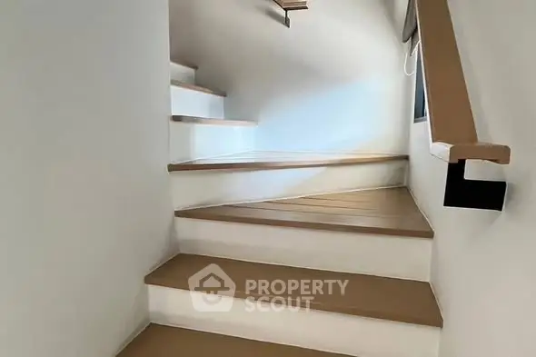 Modern staircase with sleek wooden steps and minimalist design