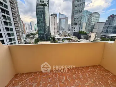 Spacious balcony with stunning city skyline views in modern high-rise building.