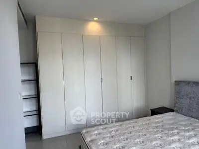 Spacious bedroom with built-in wardrobe and modern design