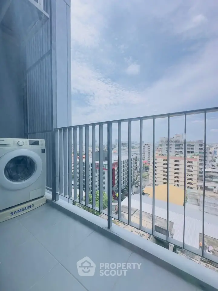 High-rise balcony with washing machine and cityscape view, perfect for urban living.