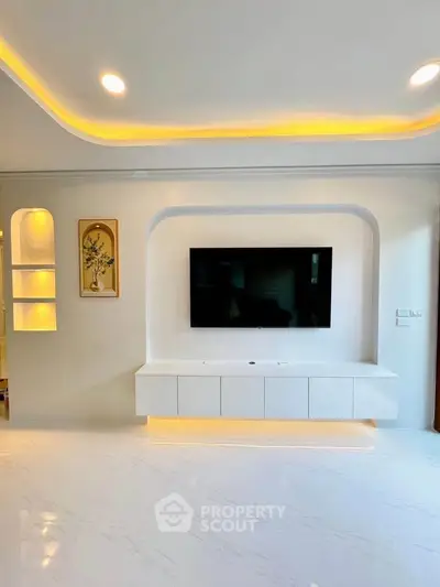 Modern living room with sleek TV setup and ambient lighting