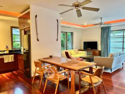 Spacious open-plan living and dining area with modern furnishings and natural light.