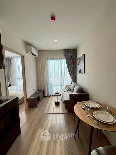 Modern living room with cozy dining area and natural light in stylish apartment.