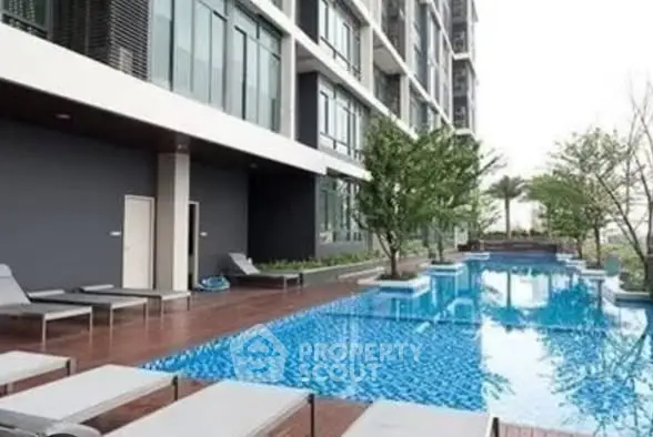 Luxurious apartment complex with stunning poolside view and modern architecture.