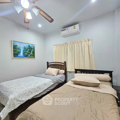 Cozy bedroom with twin beds and air conditioning in a modern home.