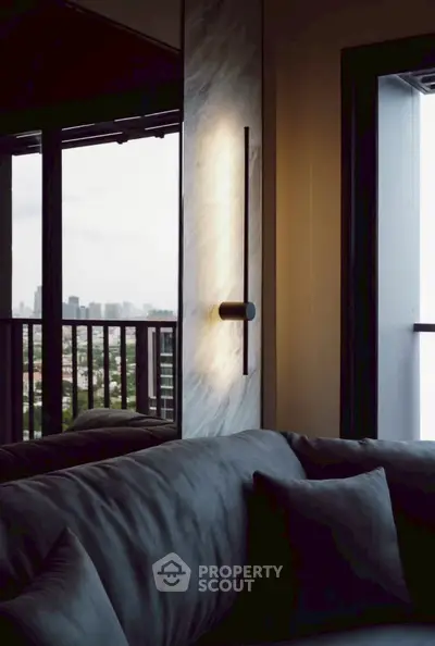 Luxurious living room with modern lighting and stunning city view from balcony.