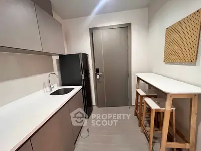 Modern compact kitchen with sleek cabinetry and breakfast bar