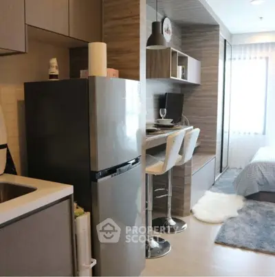 Modern studio apartment with sleek kitchen and cozy bedroom area