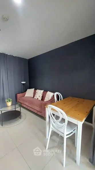 Cozy living room with modern decor, featuring a stylish sofa and dining area.