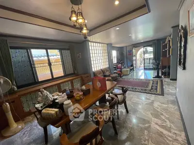 Spacious living room with elegant dining area and large windows for natural light.