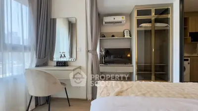 Modern bedroom with stylish decor, featuring a vanity, mirrored wardrobe, and natural light.