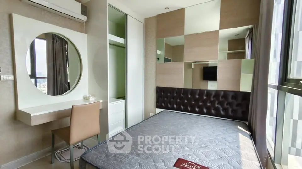 Modern bedroom with large windows and stylish decor in a high-rise apartment.