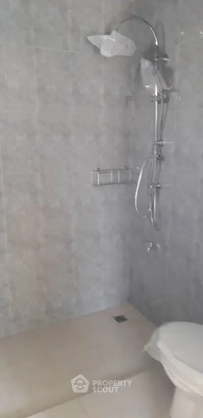 Modern bathroom with sleek shower fixtures and tiled walls