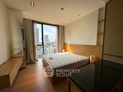 Modern bedroom with city view, featuring wooden accents and large window for natural light.