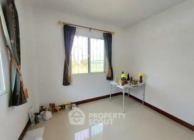 Bright and airy room with window view, ideal for customization.