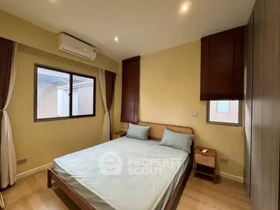 Cozy bedroom with modern design, featuring a comfortable bed and ample natural light.