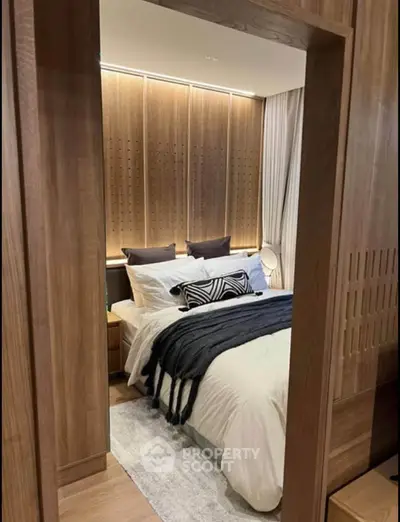 Luxurious bedroom with elegant wooden paneling and cozy bedding in modern apartment.