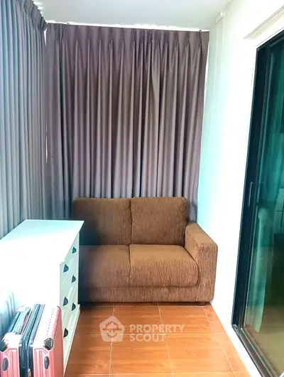 Cozy small living area with brown sofa and white cabinet, perfect for compact spaces.