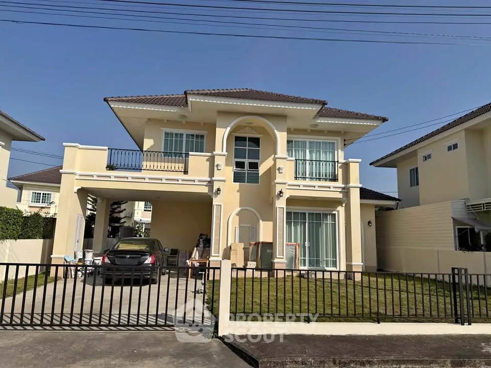 Charming two-story house with spacious driveway and manicured lawn in a serene neighborhood.