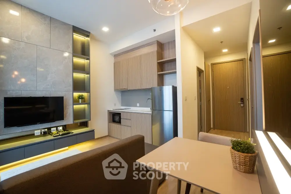 Modern open-plan living room with stylish kitchen and cozy dining area