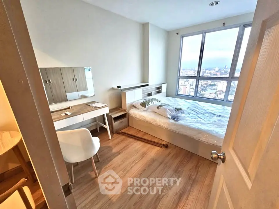 Cozy bedroom with city view, modern furniture, and natural light