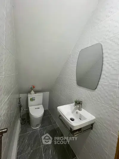 Compact bathroom with modern fixtures and stylish tile design