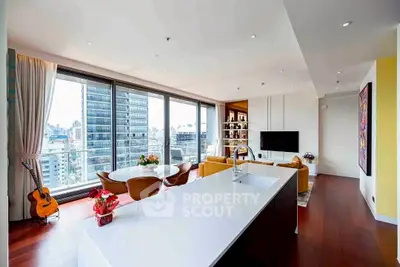 Luxurious modern living room with city view, open layout, and elegant furnishings.