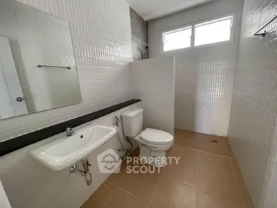 Modern bathroom with sleek white tiles and natural light