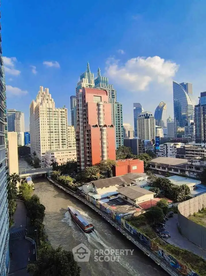 Stunning cityscape view with modern skyscrapers and a serene river, perfect for urban living enthusiasts.