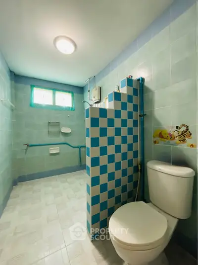 Spacious bathroom with blue checkered tiles and modern fixtures