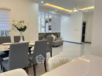 Elegant open-plan living and dining area with modern decor and stylish furniture.