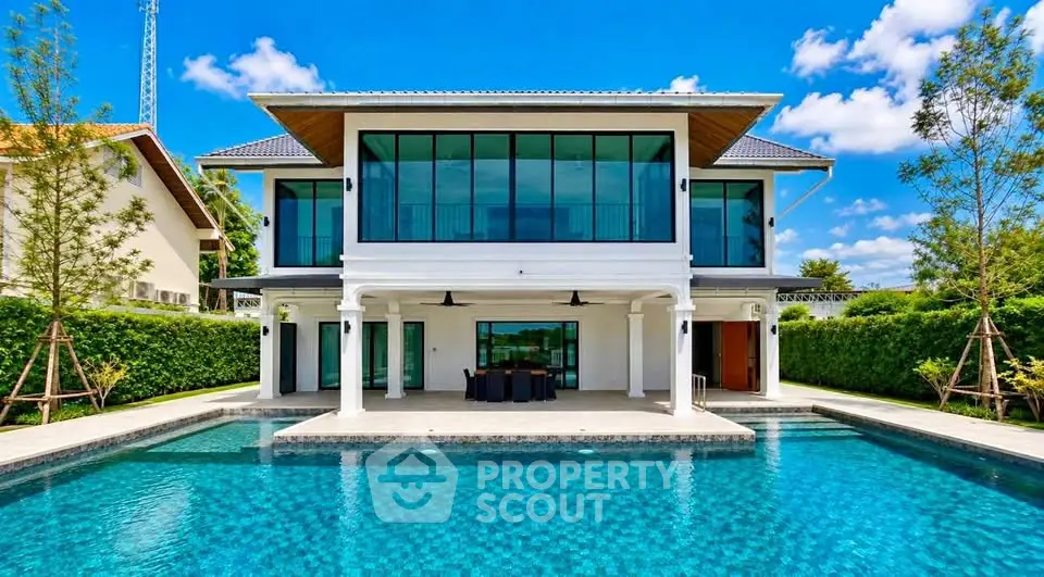 Luxurious modern villa with stunning pool and expansive glass facade