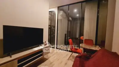 Modern living room with glass partition and stylish furniture