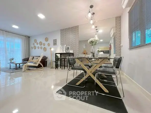 Modern open-plan living and dining area with stylish decor and ample natural light.