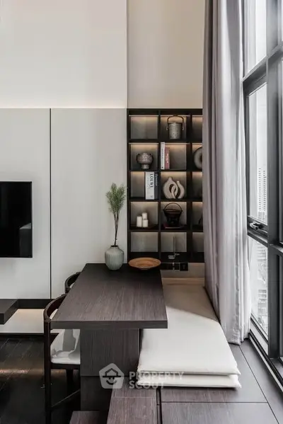 Modern living room with stylish built-in shelving and large windows