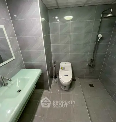 Modern bathroom with sleek fixtures and spacious shower area