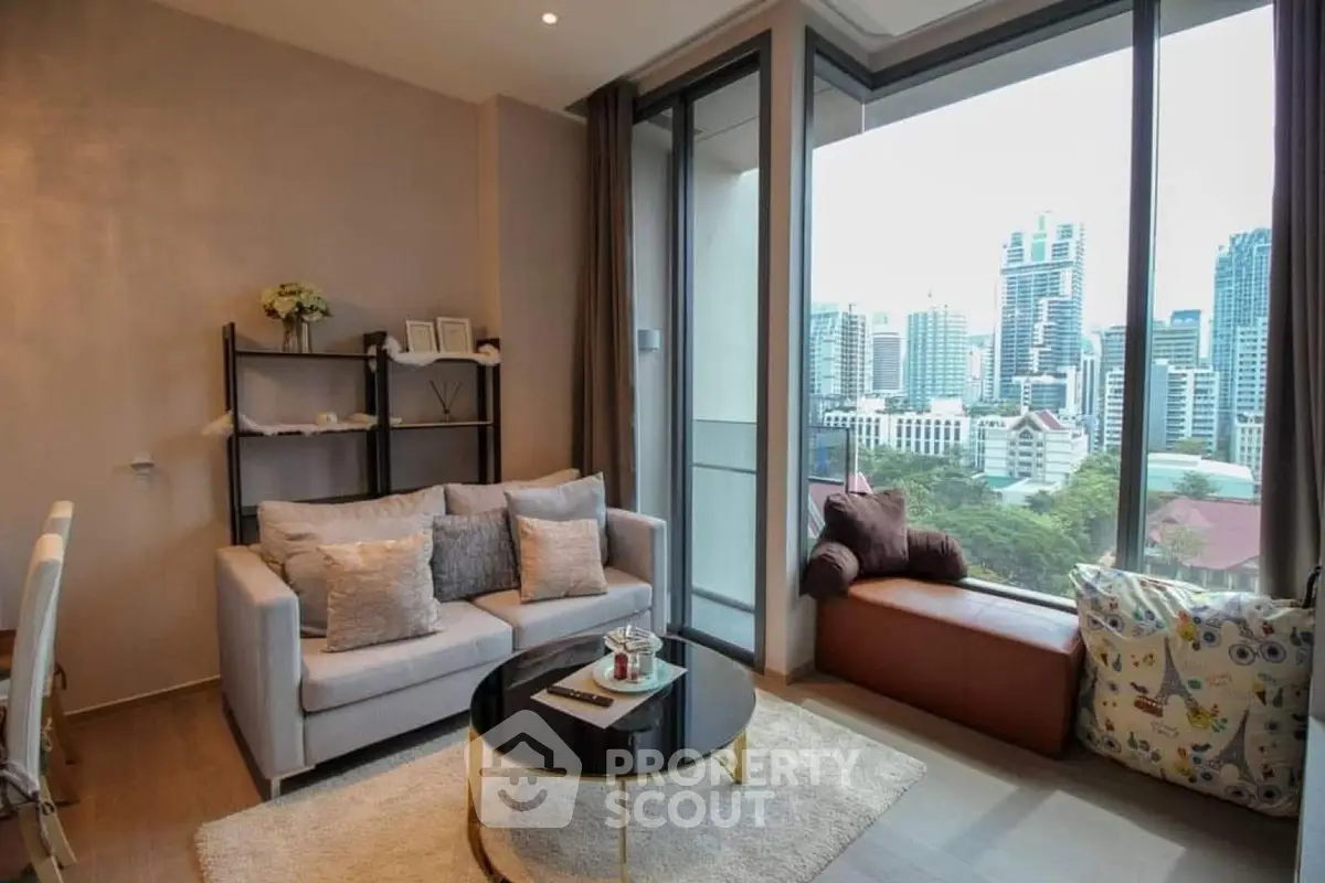 Modern living room with city view, cozy seating, and stylish decor in urban apartment.