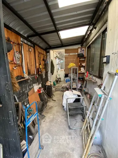 Spacious storage area with ample shelving and natural light, perfect for organizing tools and equipment.