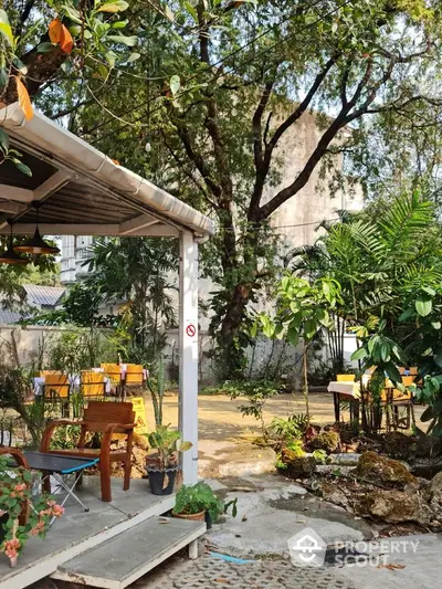 Charming garden area with lush greenery and outdoor seating, perfect for relaxation and gatherings.